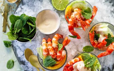 Mango and lime prawn cocktails with sesame seeds on ice